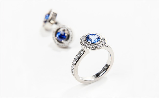 The Halo Collection – blue sapphire ring with a diamond halo, and sapphire studs with removable diamond jackets, all  in 19k white gold