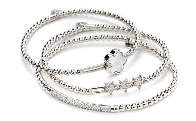18K white gold bracelets with diamonds or mother of pearl accents. The stretch mechanism is warranted to last.